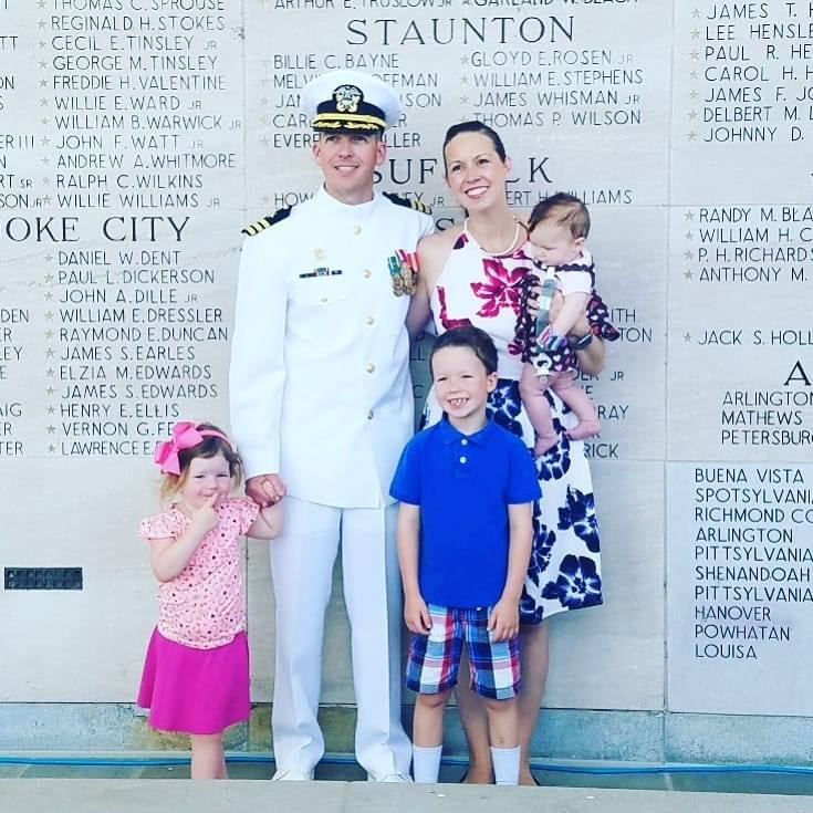 Commander Brian Scopa in Navy dress whites with his family